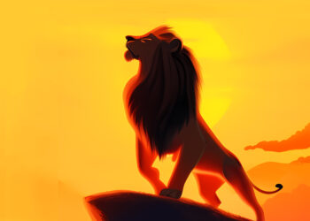 Ein majestästischer Löwe steht auf einem Feld vor einem Sonnenaufgang